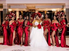 a group of women standing next to each other in red dresses