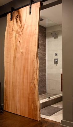 a large piece of wood sitting on top of a wooden floor next to a glass door