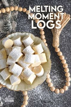 a bowl filled with marshmallows next to a wooden bead necklace on top of a table