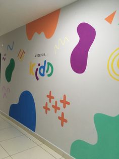 an empty hallway painted with colorful shapes and numbers