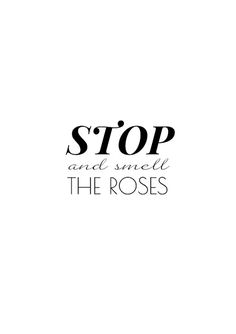 a black and white photo with the words stop and smell the roses written in cursive font