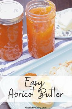 two mason jars filled with apricot butter sitting on top of a white plate