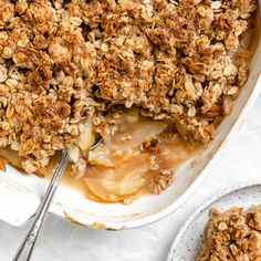 a casserole dish filled with apples and oatmeal crumbles