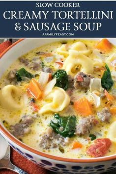 a bowl of pasta soup with meat, cheese and spinach in it on a wooden table