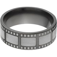 a black and white film strip ring with squares on it's sides, against a white background