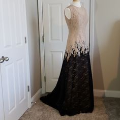 Beautiful Size 12 Black And Creme Laced Evening Gown Fit For Your Next Formal Event. Has A Small Train That Lays About 5" At Its Longest From The Front. Sleeveless With Hidden Zipper In The Back That Hooks At The Top. Creme Inner Layer That The Lace Lays Over. You Can See From The Pictures That The Lace On The Chest And Back Lays Directly On The Skin. Bust Armpit To Armpit 17.5" Waist 30" Hips 41.5" Length Shoulder To Bottom 62.5" Measurements Are Approximate And Taken With Dress Laying Flat. Lace Evening Gown With Long Train, Formal Floor-length Gown With Lace Trim, Evening Gown With Lace Trim And Floor-length, Evening Gown With Lace Trim, Floor-length Gown With Lace Trim, Formal Cream Dress With Sweep Train, Cream Lace Gown For Evening, Fitted Beige Gown With Sweep Train, Cream Floor-length Gown With Sweep Train