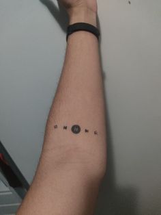 a man's arm with an arrow tattoo on the left side of his arm