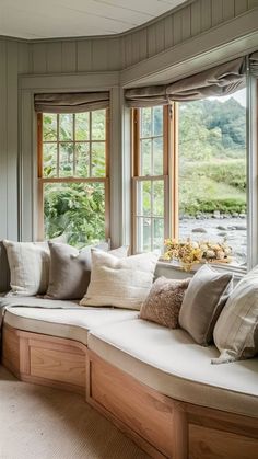 a window seat with many pillows on it