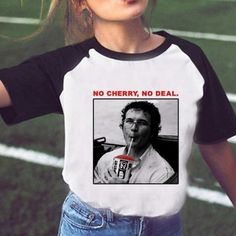 a woman wearing a white and black shirt with the words no cherry no deal on it