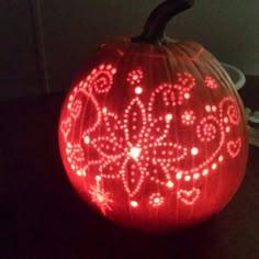 a lighted pumpkin sitting on top of a table