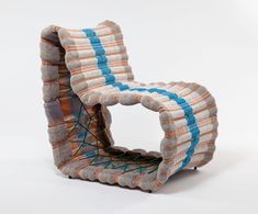 a chair that is made out of fabric and yarn with strings attached to the back