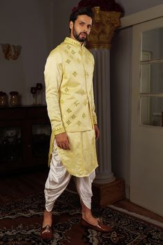 Lemon yellow silk long bundi with mirror embroidered motifs and mandarin collar. Comes with kurta and draped cowl pant.
Component: 3
Pattern: Embroidery
Type Of Work: Mirror work
Neckline: Mandarin
Sleeve Type: Bundi: Sleeveless, Kurta: Full length
Fabric: Kurta and Bundi: Silk, Cowl Pant: Satin silk
Color: Yellow
Other Details: 
Mirror embroidery
Cowl draped pant
Occasion: Destination Wedding - Aza Fashions Mirror Work Kurta, Embroidery Mirror Work, Yellow Mirror, Sleeveless Kurta, Yellow Kurta, Embroidery Mirror, Drape Pants, Types Of Work, Luxury Sale