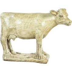 a statue of a cow is shown on a white background