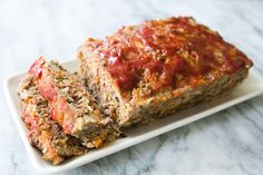 two slices of meatloaf on a white plate