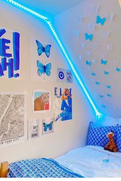 a bedroom with blue butterflies on the ceiling and white walls, along with pictures hanging on the wall