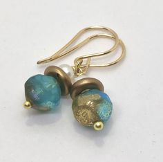 Old world feel with modern charm Artisan Gold Earrings With Czech Glass, Artisan Drop Earrings With Patina, Elegant Turquoise Earrings With Gold Beads, Elegant Green Patina Earrings, Vintage Green Patina Earrings, Handmade 14k Gold-filled Dangle Pearl Earrings, Turquoise Patina Dangle Earrings, Nugget Earrings, Aqua Glass