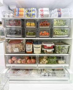 an open refrigerator filled with lots of different types of vegetables and food in plastic containers