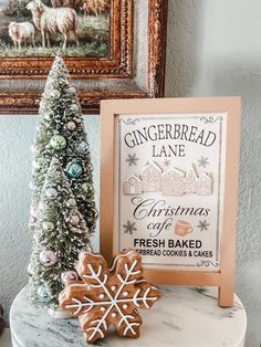 a gingerbread christmas cookie next to a framed sign with a snowflake on it