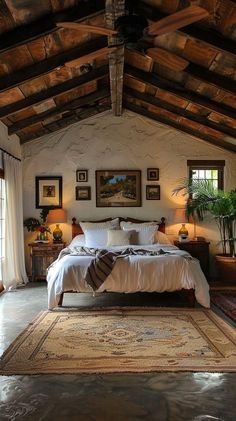 a large bed sitting under a wooden ceiling in a bedroom next to two tables and lamps