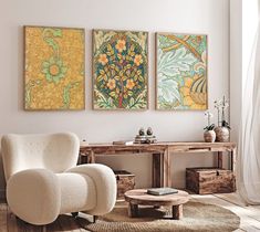 a living room with three paintings on the wall