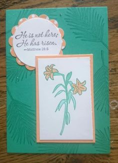 a card with a flower on it and the words he is not here he has risen