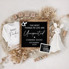 the baby announcement is displayed on top of a blanket with other items and decorations around it