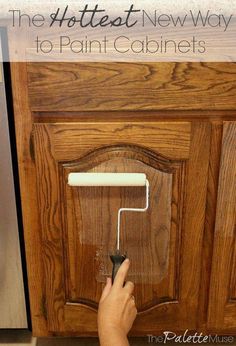 a person using a paint roller to paint cabinet doors with text overlay that reads the hottest new way to paint cabinets