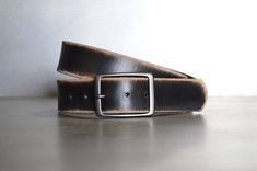 We take pride in making belts.  We use the highest quality leather to deliver an outstanding product that will last decades.  All of our Leather Belts are cut from FULL GRAIN, 9 oz., Veg tanned Double shoulders.  Our Vintage belts are distressed and antiqued to give each piece a unique finish.  These belts have a snap enclosure, so changing out buckles is simple and quick.  We also make our leather belts with 7 holes for optimum sizing for a sure fit.  Belts are 1.5" wide.Sizing is easy.  Simply Black Rectangular Leather Belt Buckles, Black Leather Rectangular Belt Buckles, Everyday Black Leather Belt Buckles, Everyday Black Leather Belt Buckle, Vintage Rectangular Leather Belt Buckles, Classic Leather Belt Buckles As Gift, Leather Brown Belt Buckles Gift, Classic Leather Belt Buckles For Gifts, Black Leather Belt Buckles As Gift