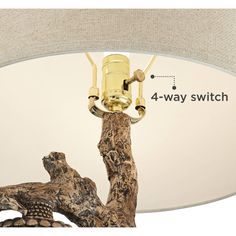 a lamp that is on top of a tree branch with the words 4 - way switch below it