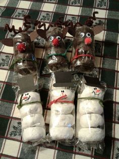 four snowmen are wrapped in plastic bags with reindeer noses and nose decorations on them