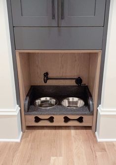 the dog bowl is built into the back of the cabinet and has two stainless steel bowls in it