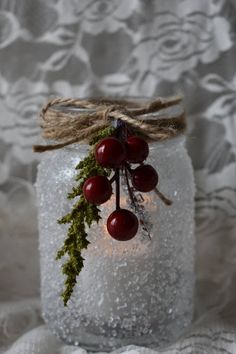 a mason jar filled with snow and berries