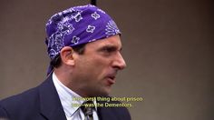 a man in a suit and tie with a purple bandanna on his head is talking to someone