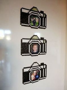 three legos are hanging on the wall in front of a door with two pictures attached to it