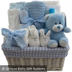 a blue teddy bear sitting next to a basket filled with baby items and the words home & garden essentials