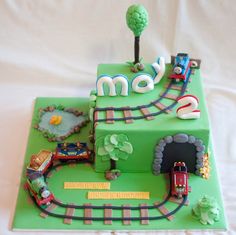 a birthday cake made to look like a train track with the name mom on it