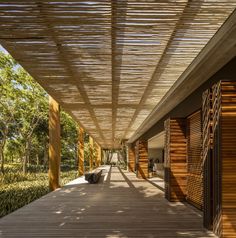 an outdoor covered walkway with wooden slats