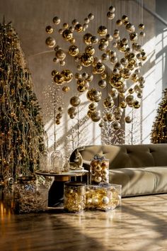 a living room decorated for christmas with gold ornaments hanging from the ceiling and decorations on the wall