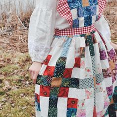 a woman wearing a dress made out of patchwork material