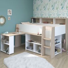 a bedroom with a bed, desk and shelves on the floor in front of a blue wall