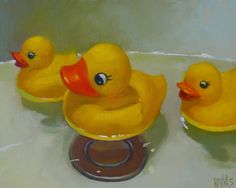 three yellow rubber ducks sitting on top of a table