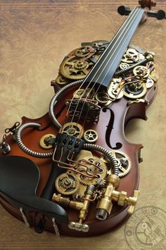 a violin made out of mechanical parts sitting on top of a table