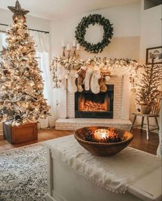 a living room with a christmas tree and fireplace