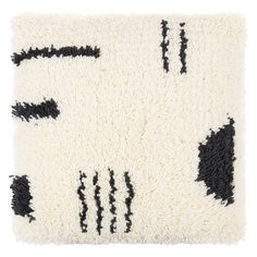 a white rug with black and white designs on it