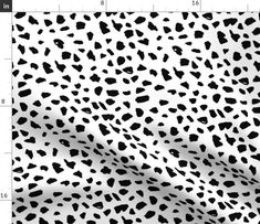 a white and black animal print fabric with an area for the ruler to be shown