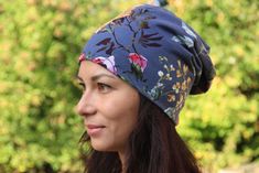 a woman wearing a blue floral head wrap