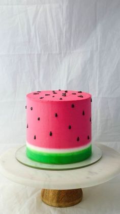 a watermelon cake sitting on top of a white plate