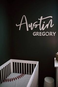 a baby's room with black walls and white crib