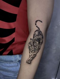 a woman with a tiger tattoo on her arm