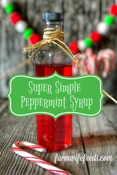 a bottle filled with peppermint syrup next to candy canes